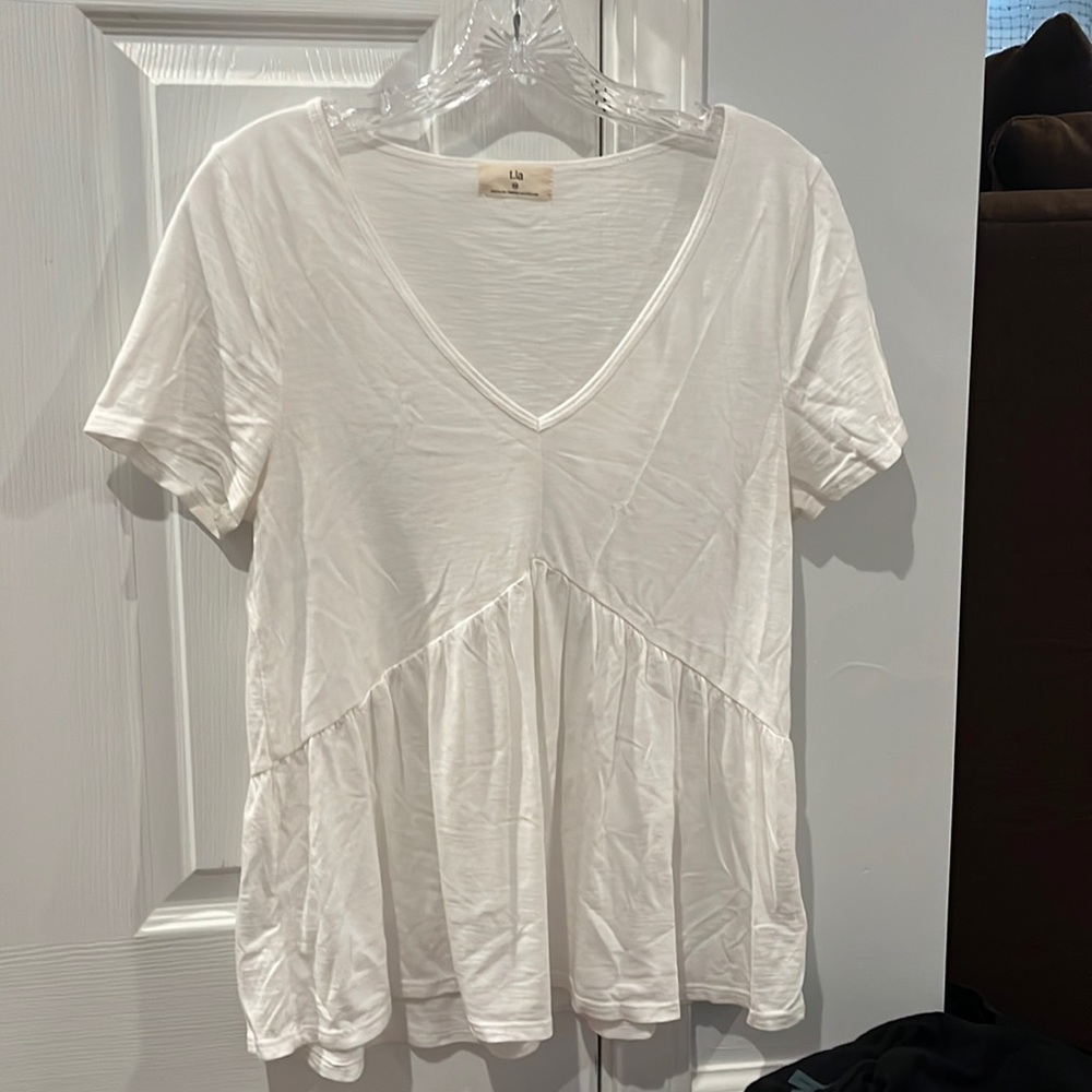 T. La shirts from Anthropologie. White is XS, orange is S, and striped is XS